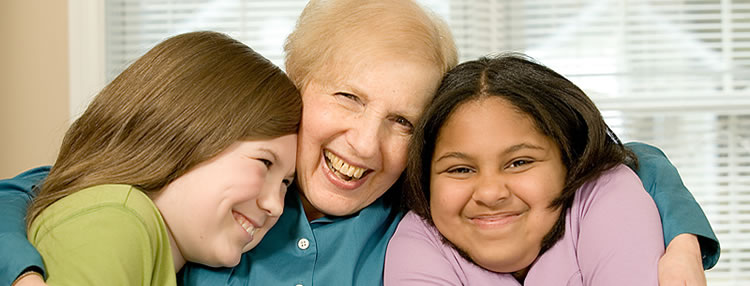 Lady hugging two girls