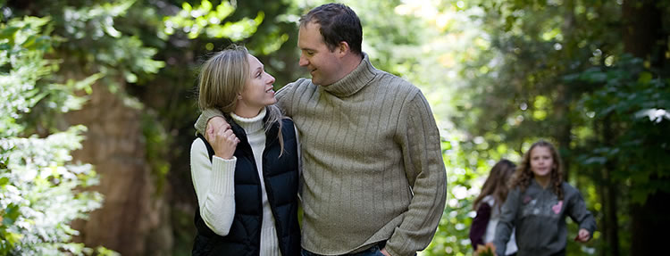 Couple walking through park
